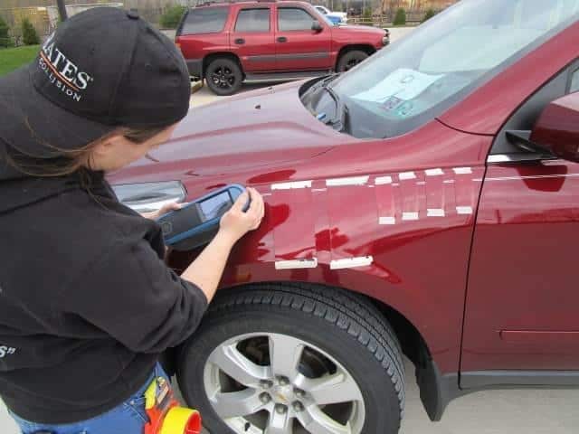 a technician working on a car at Bates Collision